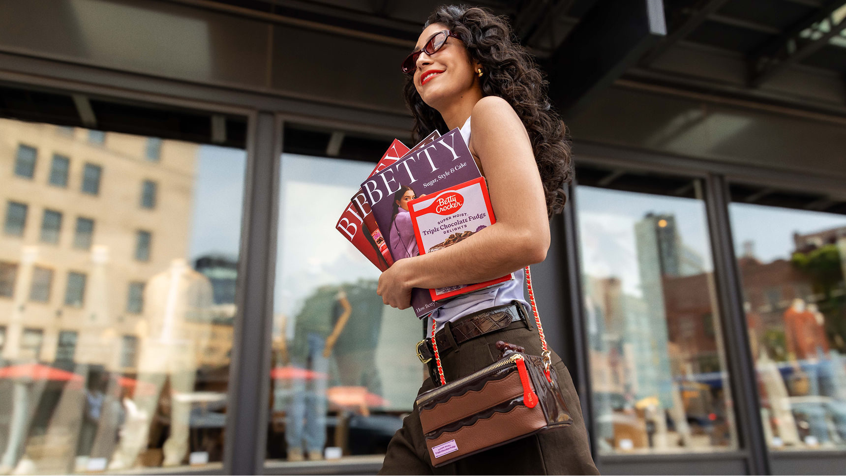 Woman walking with the chocolate The Betty Ate Collection bag